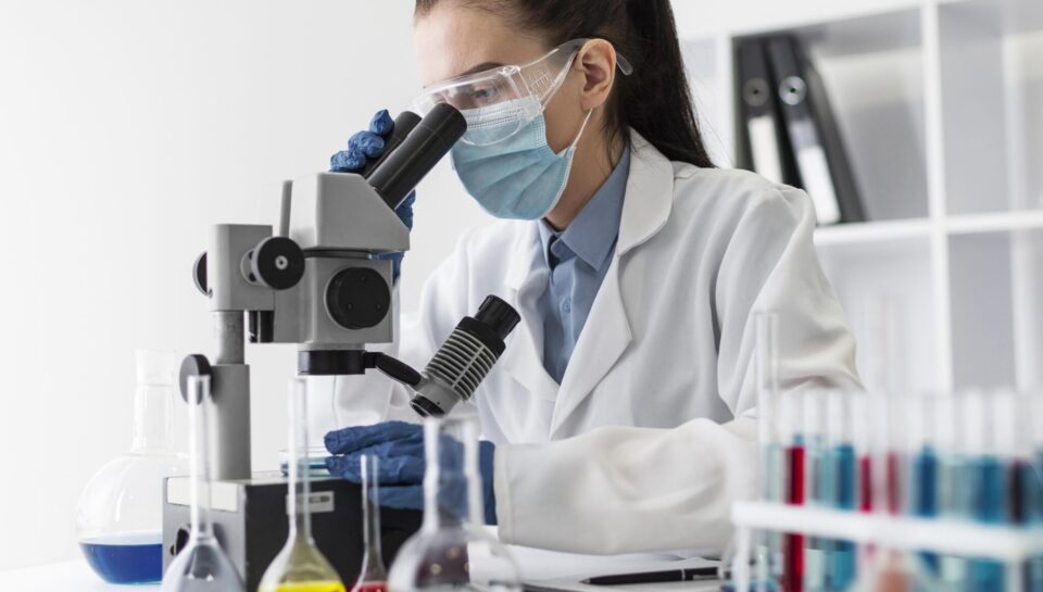 medium-shot-woman-looking-through-microscope-2048x1463